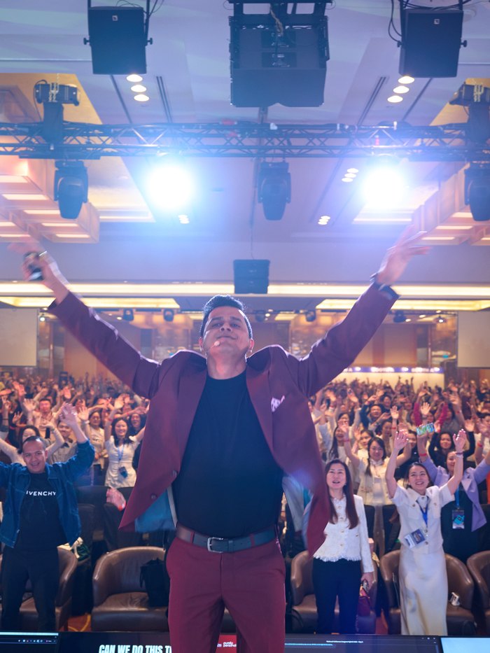 Daniel Paul on stage in front of a full room