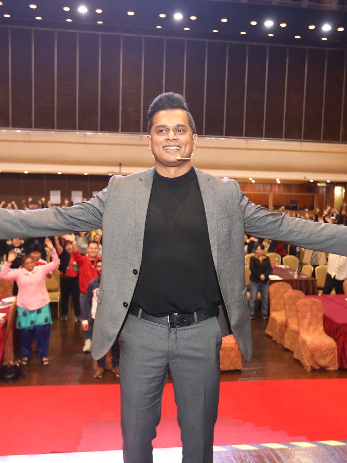 Daniel Paul on stage, audience standing